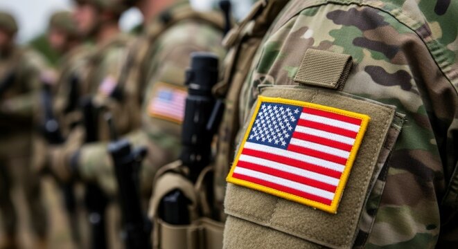 American soldiers standing in line with guns and usa flag patches on uniforms