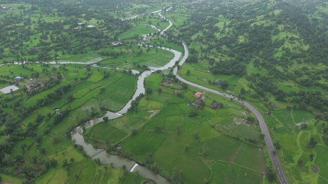 Aerial Drone View of Bhandardara Landscape with Green Valley River and Monsoon Clouds Maharashtra India