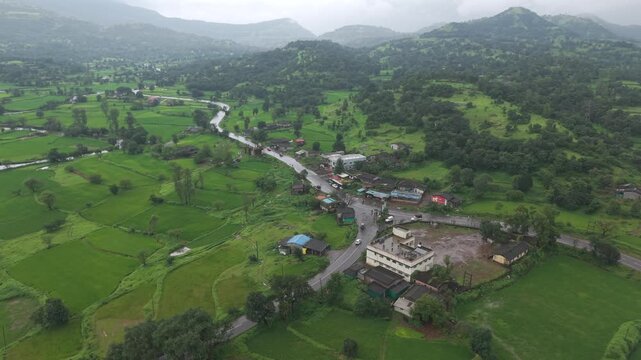 Aerial Drone View of Bhandardara Landscape with Green Valley River and Monsoon Clouds Maharashtra India