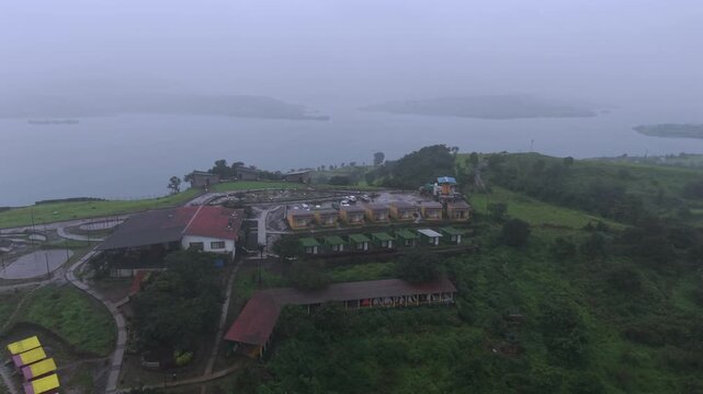 Aerial Drone View of Bhandardara Landscape with Green Valley River and Monsoon Clouds Maharashtra India