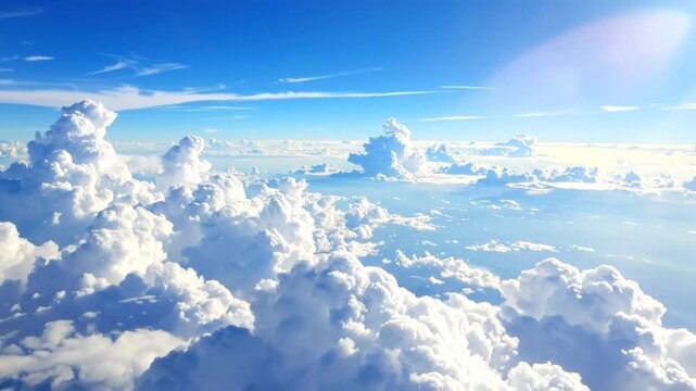 Aerial view of f white clouds floating in a bright blue sky, creating a serene and peaceful atmosphere.