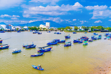 Traditional Vietnamese wooden fishing boats on the Cai River in the port. Panorama top view of Cai River in Nha Trang in Vietnam