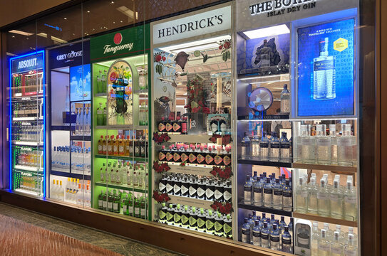 Changi, Singapore - Jan 14, 2026: A retail display at Changi International Airport showcasing various premium spirits brands including Absolut Vodka, Grey Goose, Tanqueray and Hendrick Gin.