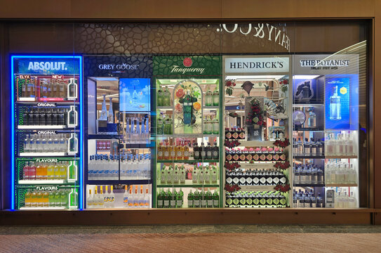 Changi, Singapore - Jan 14, 2026: A retail display at Changi International Airport showcasing various premium spirits brands including Absolut Vodka, Grey Goose, Tanqueray and Hendrick Gin.