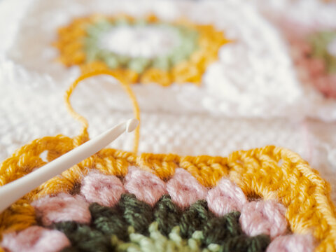 Crocheting colorful granny square blanket for hobby craft projec
