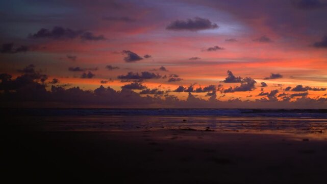 Vivid pink and purple sunset sky over Kelating Beach at dusk