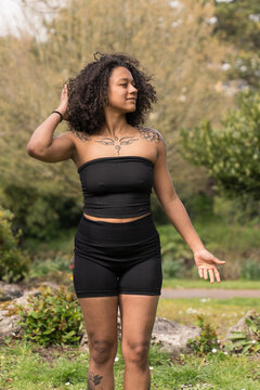 Young woman with curly hair practicing mindfulness outdoors
