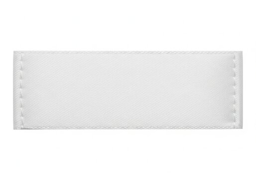 A blank white leather label with stitched edges on a plain background