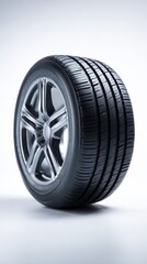 Obraz premium High quality car tire with stylish alloy rim isolated on light background