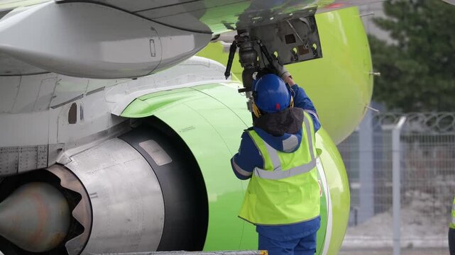 Airplane fueling. Airport technician man refueling aircraft. Terminal airline maintenance crew aviation kerosene fuel. Preparing for departure