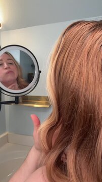 checking for wrinkles in the mirror