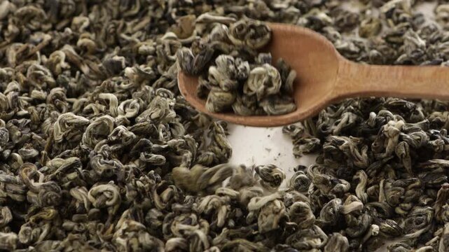 close up of dry green tea wooden spoon food texture
