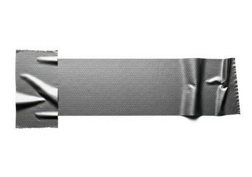 A close-up view of a crumpled silver foil wrapper on a plain white background