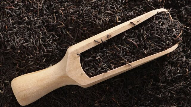 black tea leaves and wooden spoon food backgroud zoom