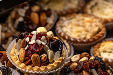 Fototapeta premium Poppy seed cake with fruit arranged in the refrigerator at the pastry shop, poppy seed cake, sweet desserts baked with homemade methods, food for the holidays, light and healthy desserts made from cak