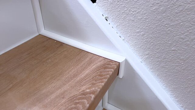 Corner detail of stair tread and wall