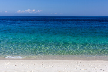 Fototapeta premium Tropical beach at Koh Adang, Thailand. Clear turquoise water meets sandy shoreline. Part of Tarutao National Park, serene coastal scene.