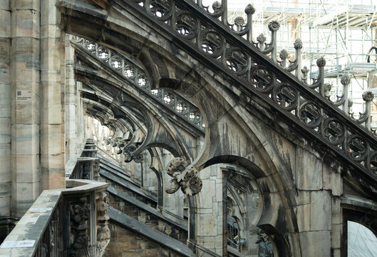 Visiting rooftop terrace of Duomo di Milano cathedral with panoramic views over Milan Italy.