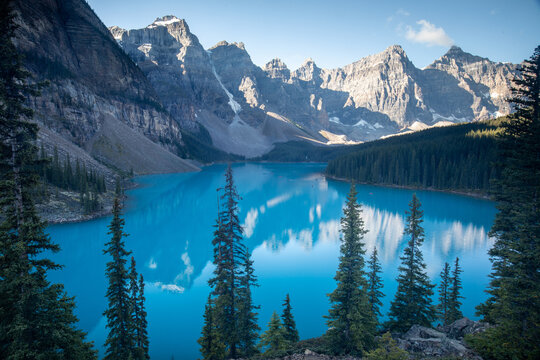Turquoise Alpine Lake Surrounded by Rocky Mountains and Pine For
