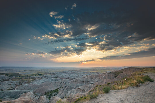 Sunset Over Badlands Landscape With Dramatic Crepuscular Rays an