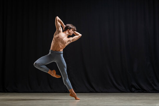 professional male dancer performs contemporary ballet on stage.