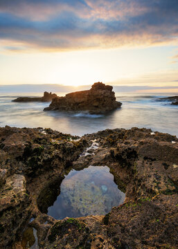 Natural Rock Arch over the Sea at Sunset