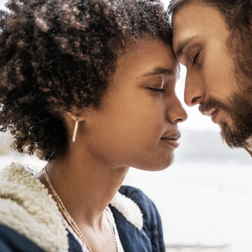 Guy with an african american girl in love in autumn park makes h