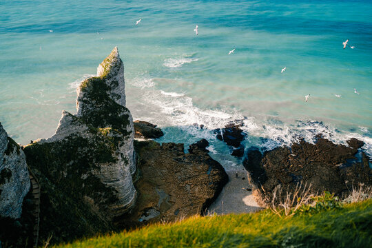 Cliffs and sea at Etretat, Normandy, with birds flying above and waves