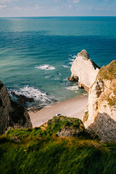 Etretat, Normandy, sunny day with waves shore and rocks visible