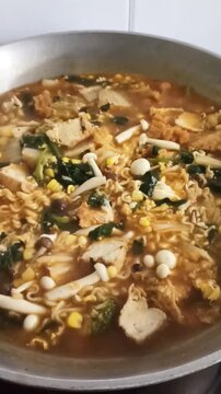 a cuisine photo of budae jjigae soup. close up view of delicious asian food
