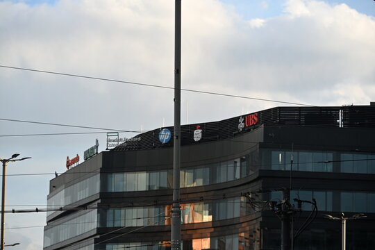 Modern Office Building Facade With Corporate Logos of HP, UBS and PKO, Business District Concept