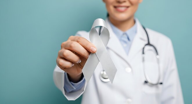 Doctor in white coat holding a silver awareness ribbon