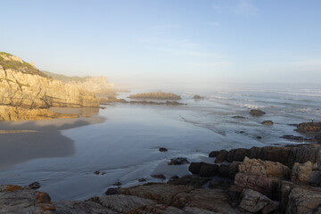 Fototapeta premium rocky coastline at sunset Kammabaai Beach, Hermanus, South Africa