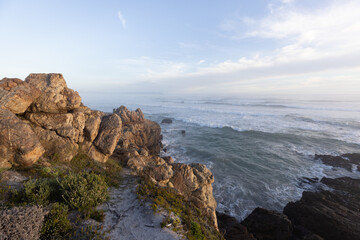 Naklejka premium rocky coastline at sunset Kammabaai Beach, Hermanus, South Africa