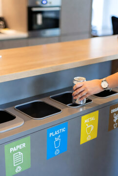 Woman sorting waste and recycling aluminum can at home