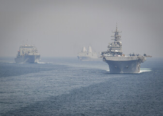 STRAIT OF HORMUZ U.S. Navy and Coast Guard ships participates in a photo exercise while transiting the Strait of Hormuz,  Sioux City is deployed to the U.S. 5th Fleet area of operations to help ensure © Mubin
