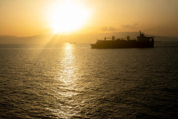 cargo ship at sunset © Mubin