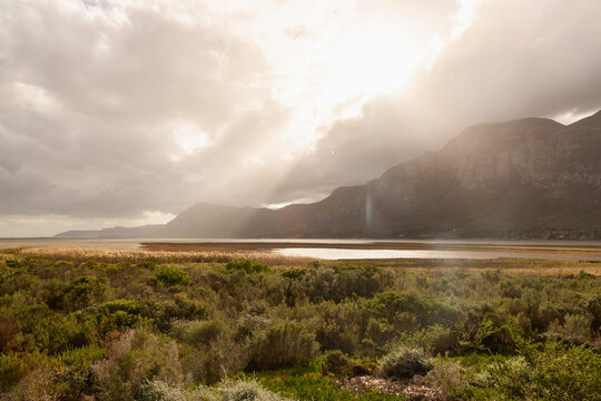 sunlight over fields, lagoon and Klein Mountain, Stanford, South Africa