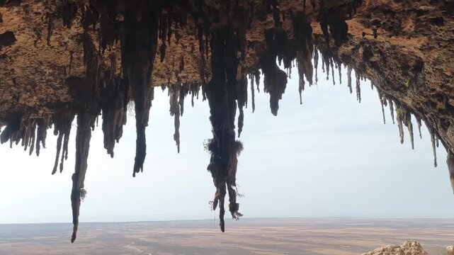 Aerial footage flying out from a cave with stalactites in Socotra, yemen