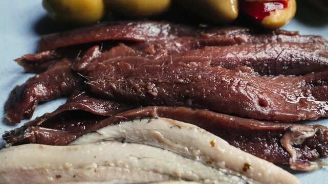 Traditional Catalan snacks for wine, beer and vermouth include green olives and anchovies.