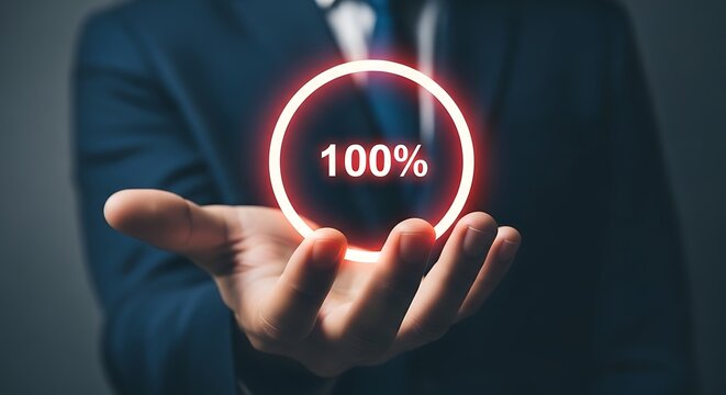 Man holds glowing 100% achievement circle