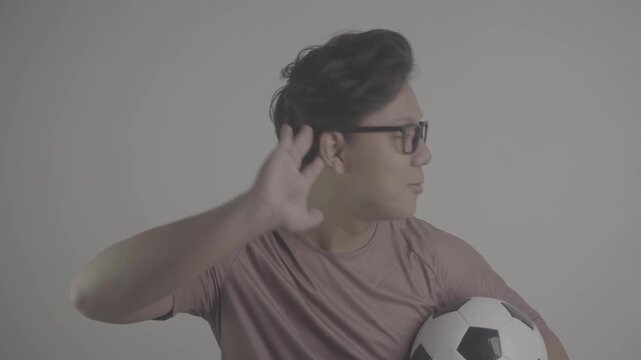 Southeast Asians person cup their ears while carrying soccer ball S-Log3, S-Gamut3.Cine