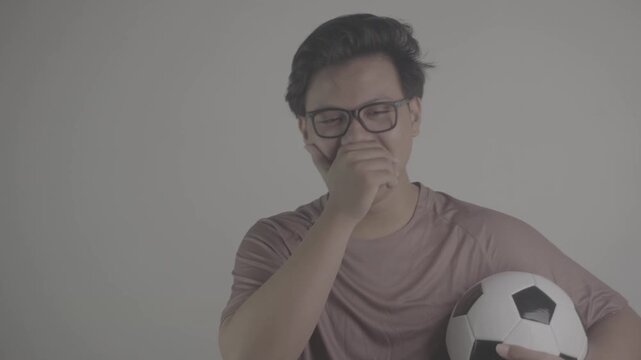 Southeast Asian person laugh at the losing team while carrying soccer ball S-Log3, S-Gamut3.Cine