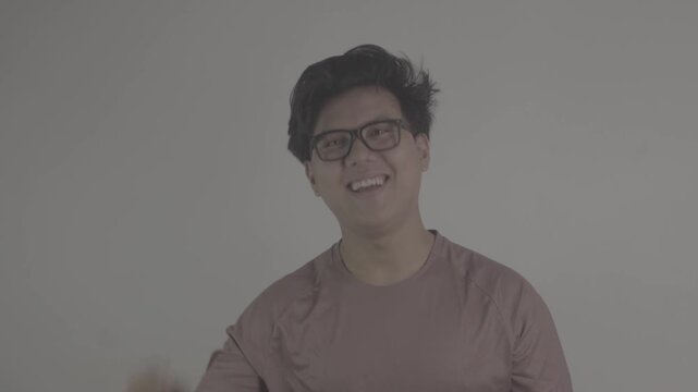 Southeast Asian person wearing brown jersey raises his finger as he has come up with an idea. S-Log3, S-Gamut3.Cine