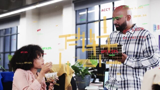 Seated woman pausing mid-bite while standing man holding tablet showing APY overlays across scene