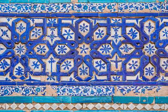 Closeup view of traditional ancient blue glazed tile floral decor on brick at Baha'al-Halim tomb, Uch Sharif, Bahawalpur, Punjab, Pakistan