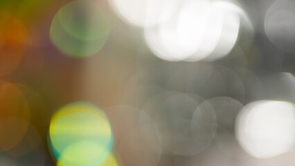 Obraz premium Abstract bokeh background with colorful blurred light circles on gray and brown