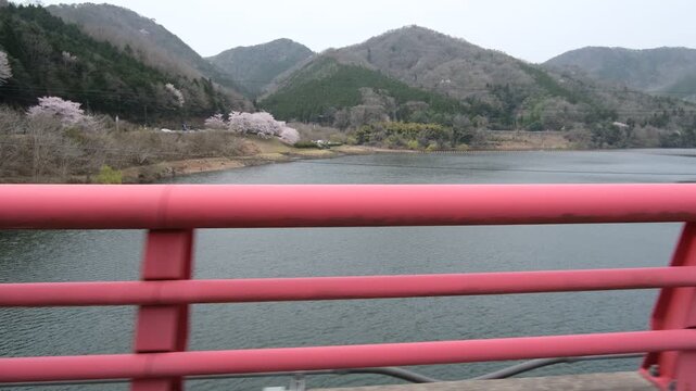 Driving Across Bridge with Landscape Passing Sideways from Car Window