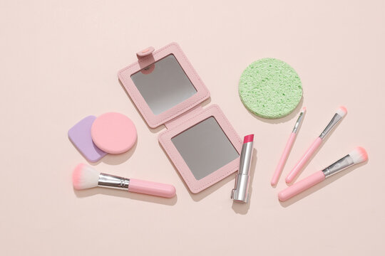Set of cosmetic products for makeup on a beige background with shadow. Beauty concept. Flat lay