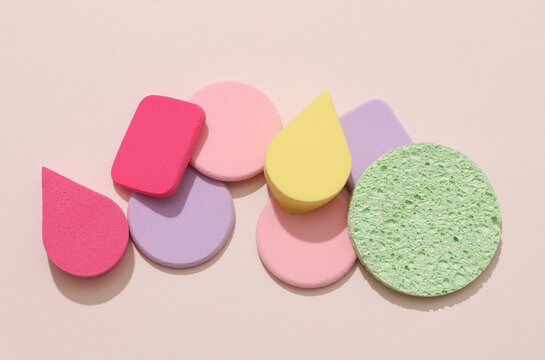 Makeup sponge pads on a beige background. Beauty products